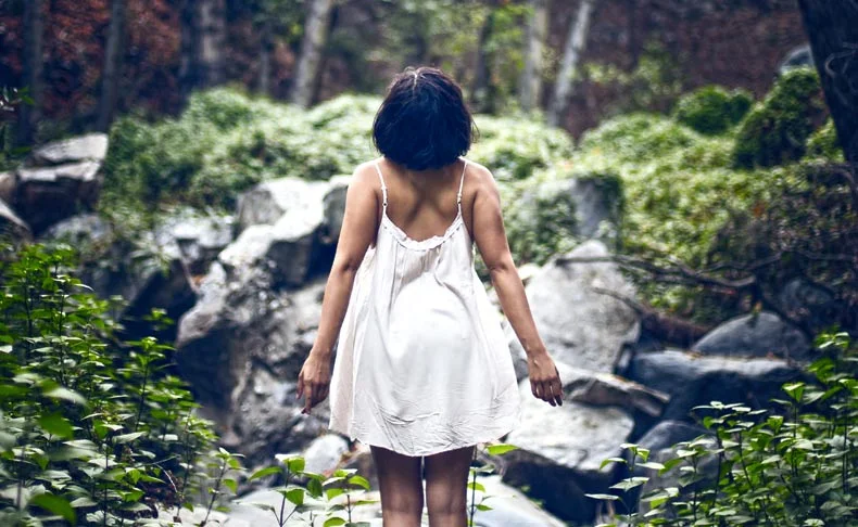 woman walking in the forest for health benefits